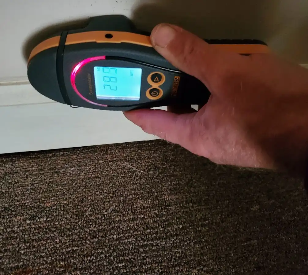Moisture detection at baseboard during Storm Damage Restoration in Forks